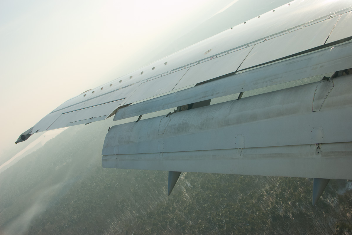 Boeing 737 wing with trailing-edge flaps extended for landing.